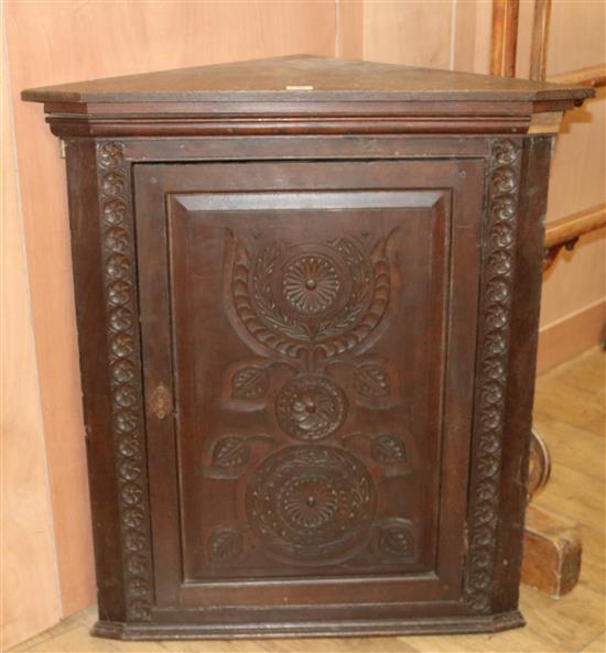 A Victorian carved oak hanging corner cupboard, W.102cm